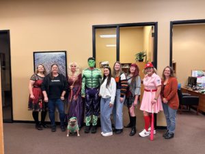 torkelson-associates-halloween-2025 Staff of Torkelson & Associates CPAs dressed for Halloween 2025 posing with big smiles in the office.